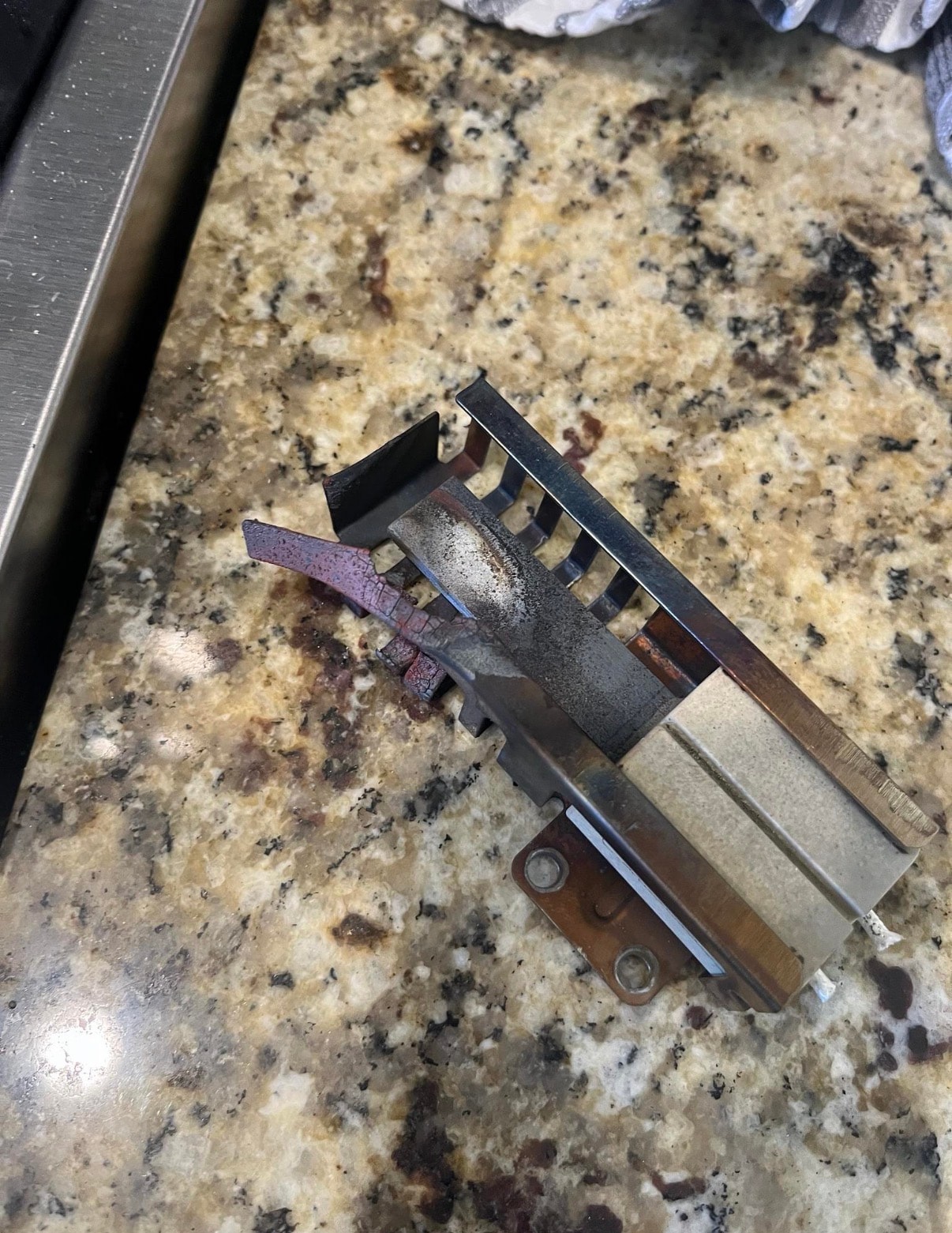 Failed Empava oven igniter removed — cracked ceramic element confirmed failure
