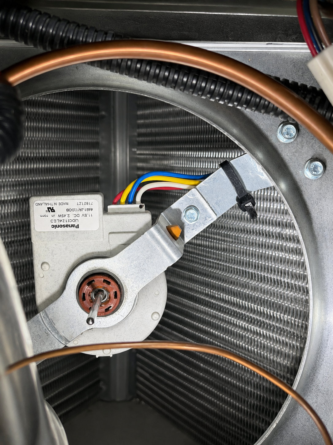 New condenser fan motor installed on GE Monogram ZISB480DMA condenser assembly — wiring harness secured with zip tie — Englewood, CO