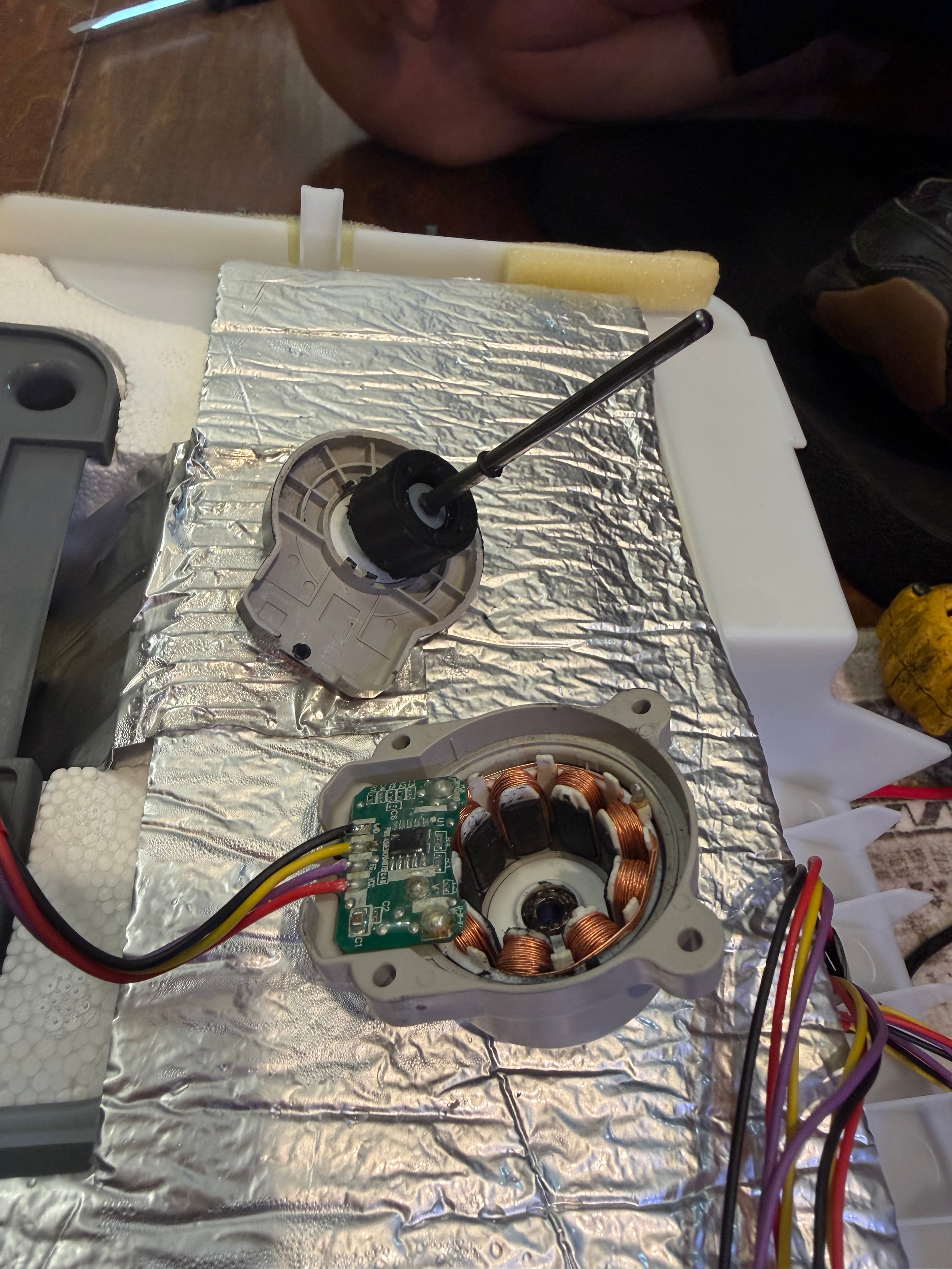 Failed LG ice room evaporator fan motor next to new OEM replacement EAU65058313
