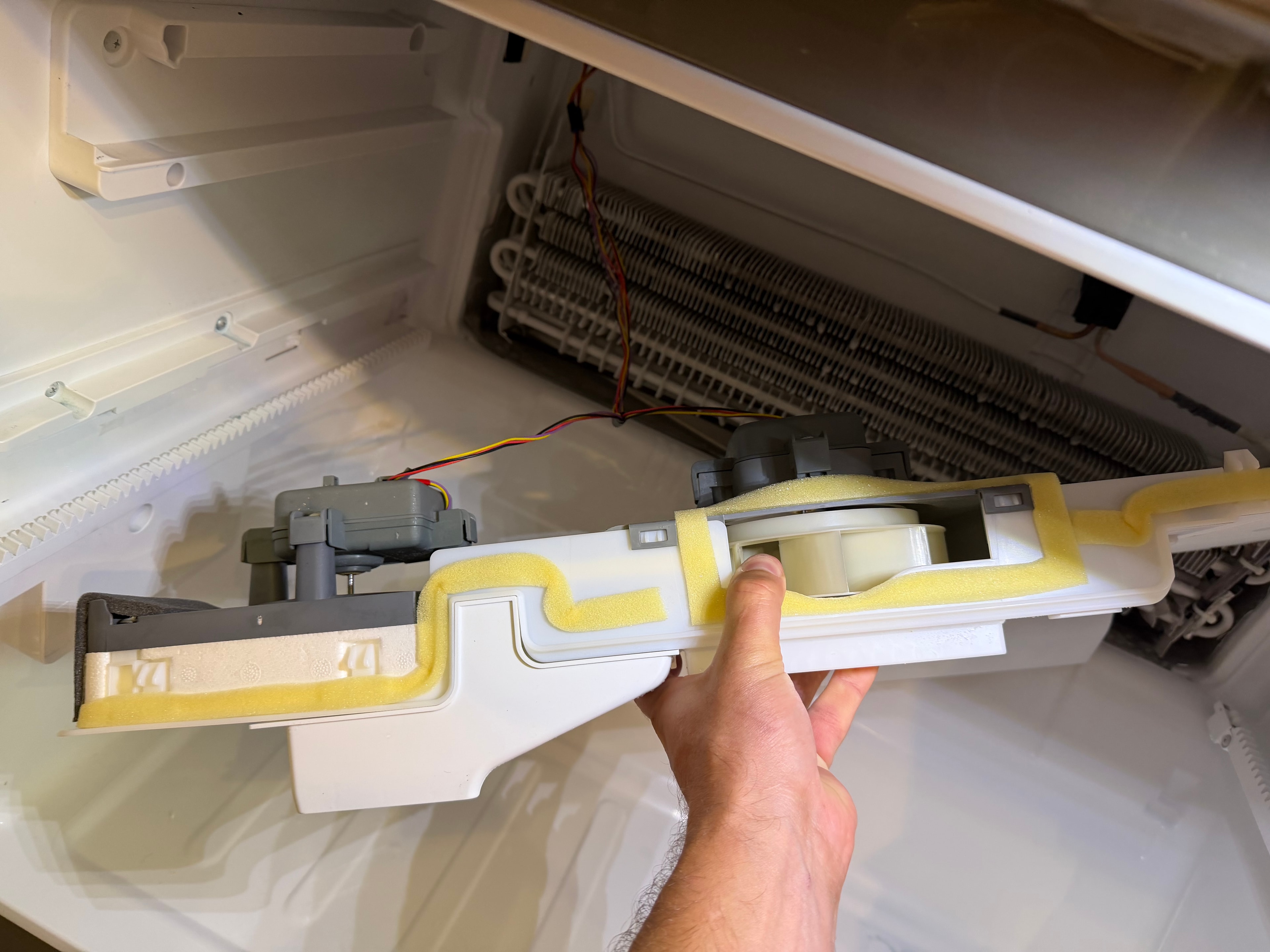 LG refrigerator ice room evaporator housing removed — fan motor assembly exposed for inspection