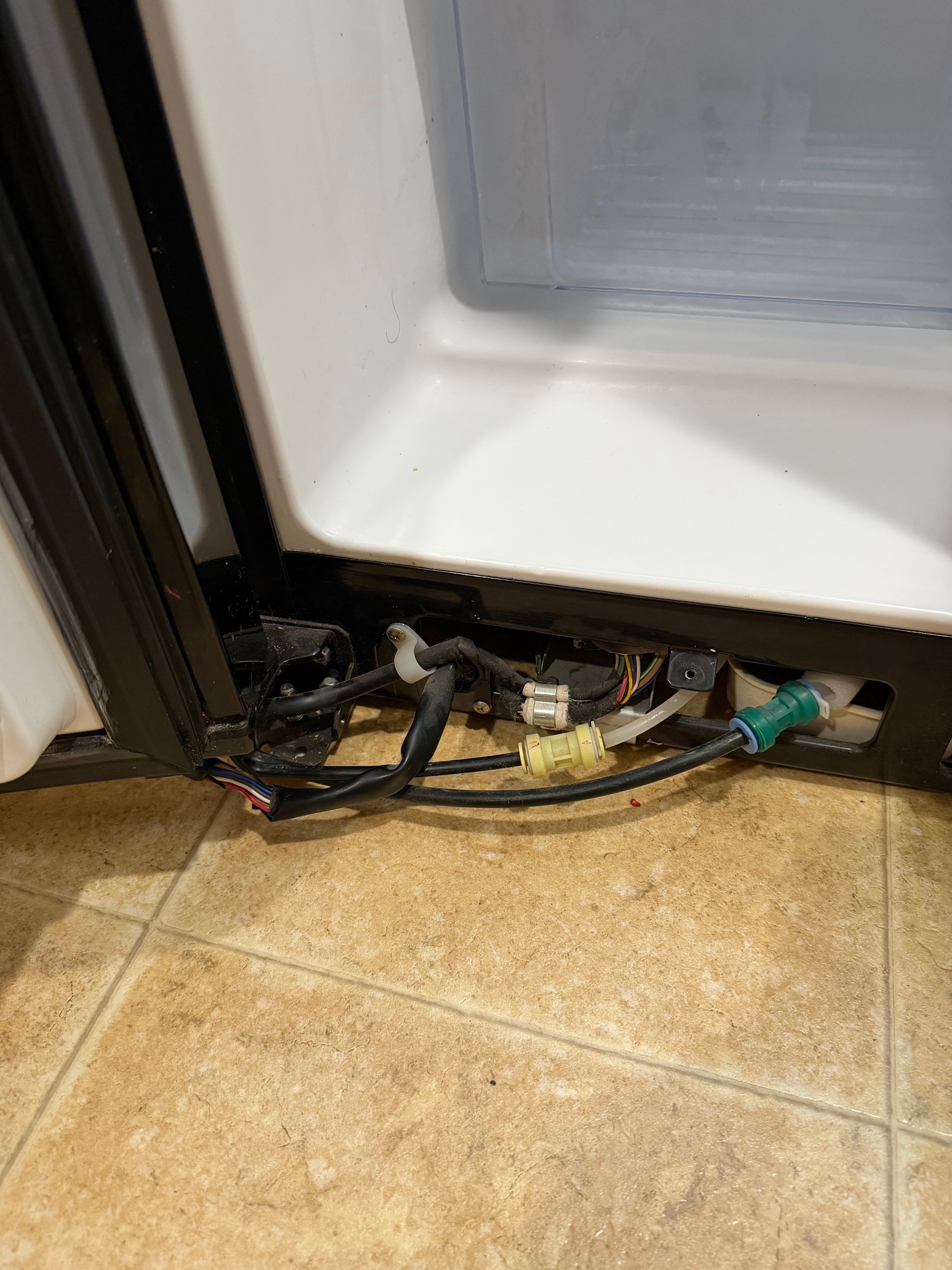 Lower kick plate removed from the Whirlpool refrigerator exposing the bottom hinge area — Lowry Denver
